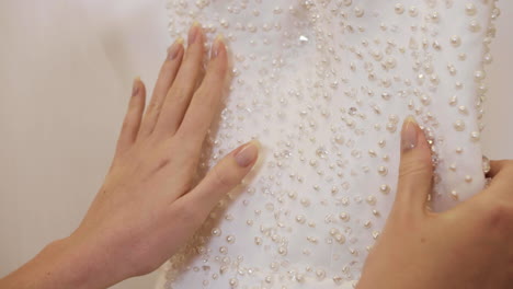 unrecognizable woman choosing wedding dress