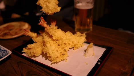 savoring tempura with beer at a restaurant