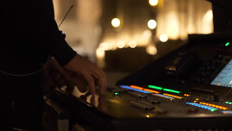 Sound-technician-hands-adjust-audio-before-concert,-close-up-view