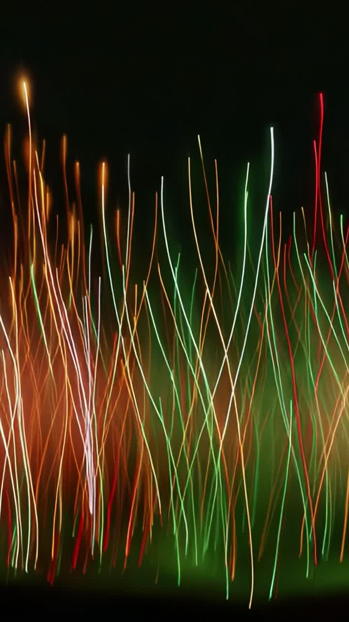 A mesmerizing display of vibrant lights dances across the darkness, intertwining in a kaleidoscope of colors, showcasing the dynamic interplay of illuminated strands in a stunning abstract representation of movement and energy