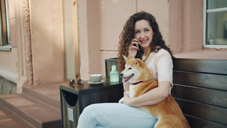 woman with shiba inu dog in a cafe