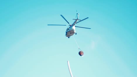 helicóptero volando después de arrojar agua sobre el fuego