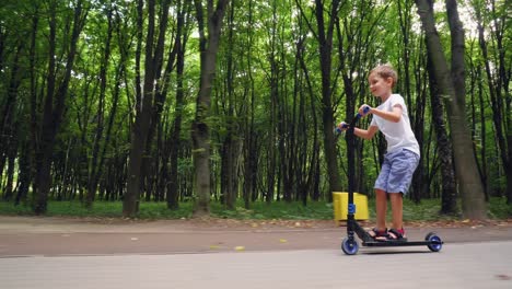 a boy rides a scooter in a city park 13