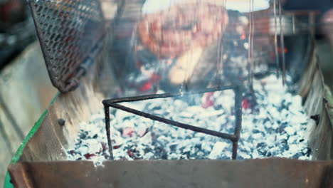 closeup of traditional south african sausage grilled on hot coals of wood fire
