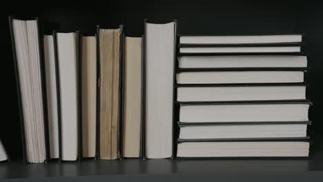 books stacked on the shelves within the library of a home