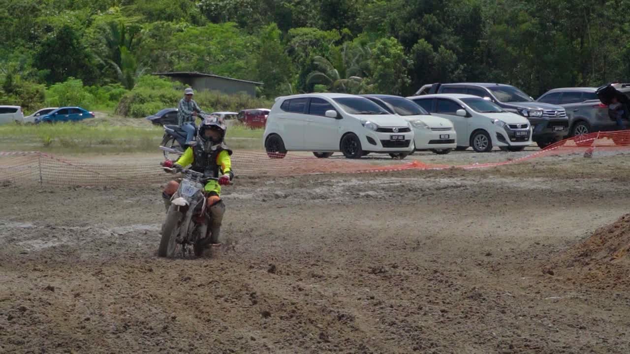 Young Boy Riding Dirt Bike on Motocross Track