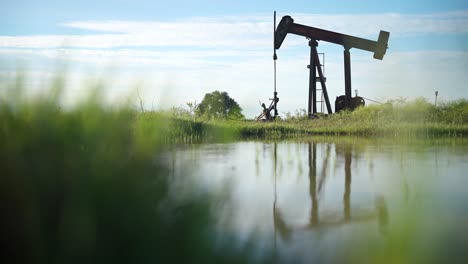 pump jack next to lake in rural texas