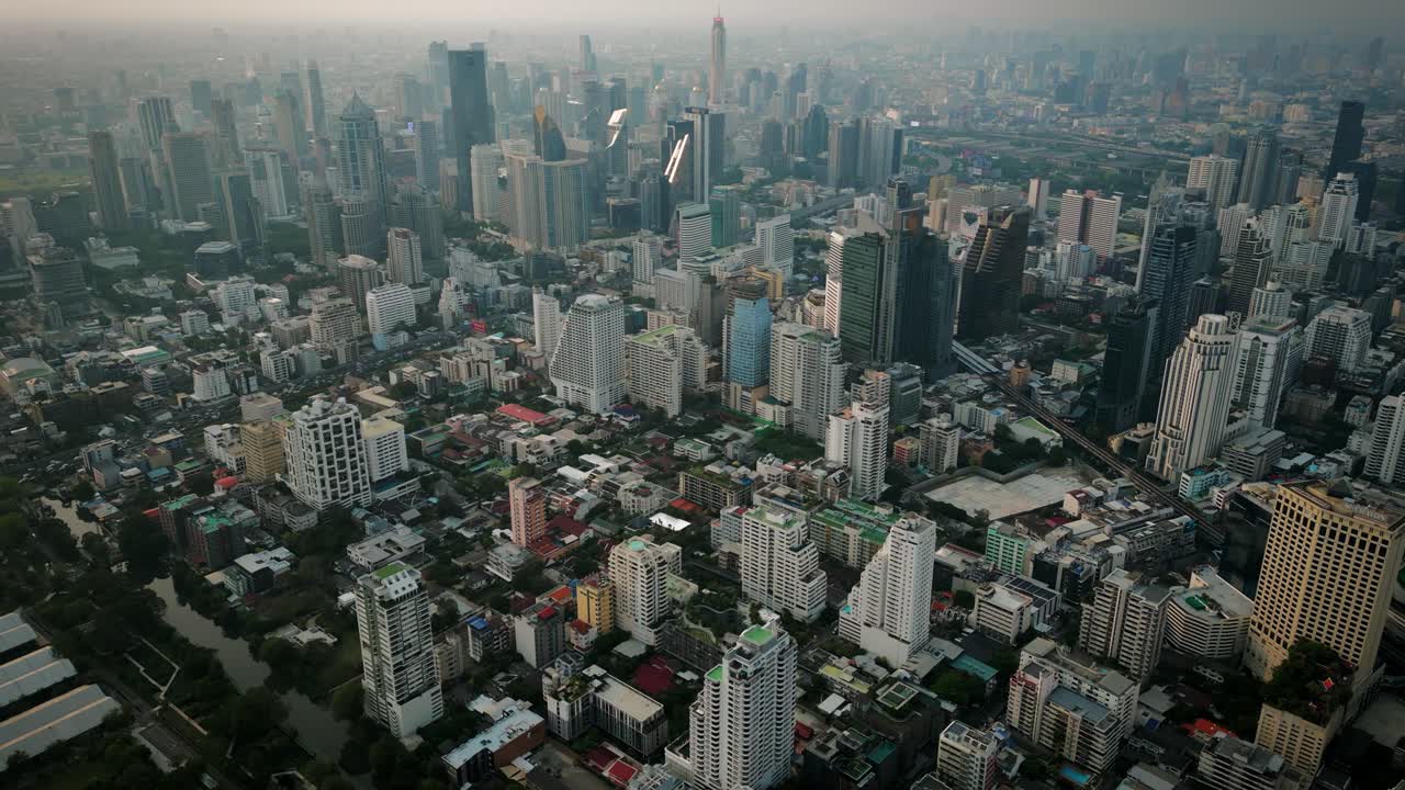 Aerial Scenic Drone Footage of the Skyline of Downtown Bangkok, Thailand Covered in Smog during Sunset during the Smokey Burning Season