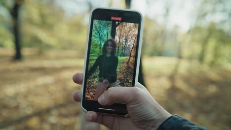 Caucasian-woman-recording-how-her-female-friend-dancing-in-the-park.