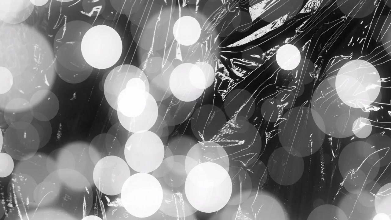 Animazione di luci bokeh su uno sfondo astratto in bianco e nero.