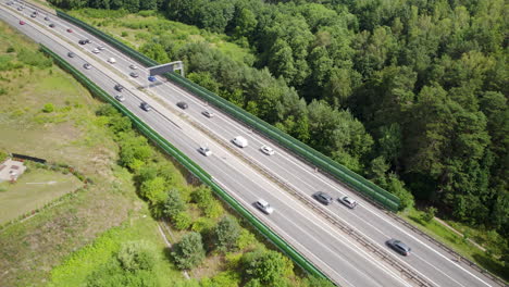 aerial drone shot of rural highway with traffic on asphalt at summer - many vehicles during journey vacation