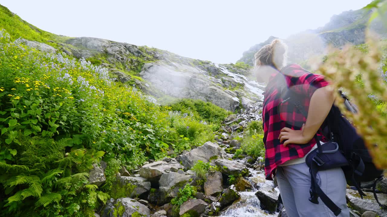 mujer mochilera disfrutando de senderismo en la montaña