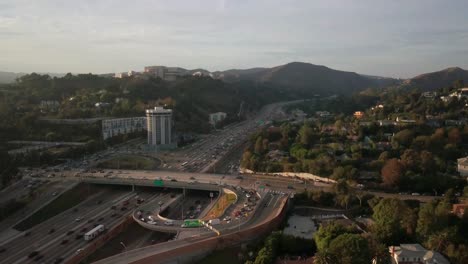 Slow-rising-aerial-pan-of-traffic-patterns-during-rush-hour-on-the-freeway-in-West-Los-Angeles