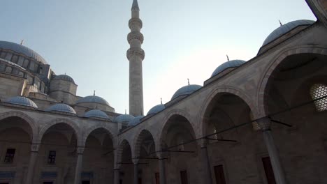 panorama view suleymaniye mosque courtyard archway against blue sky. istanbul