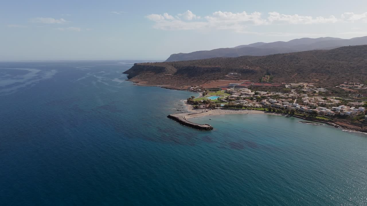 Aerial - private hotel beach and bay with turquoise waters in Crete Greece