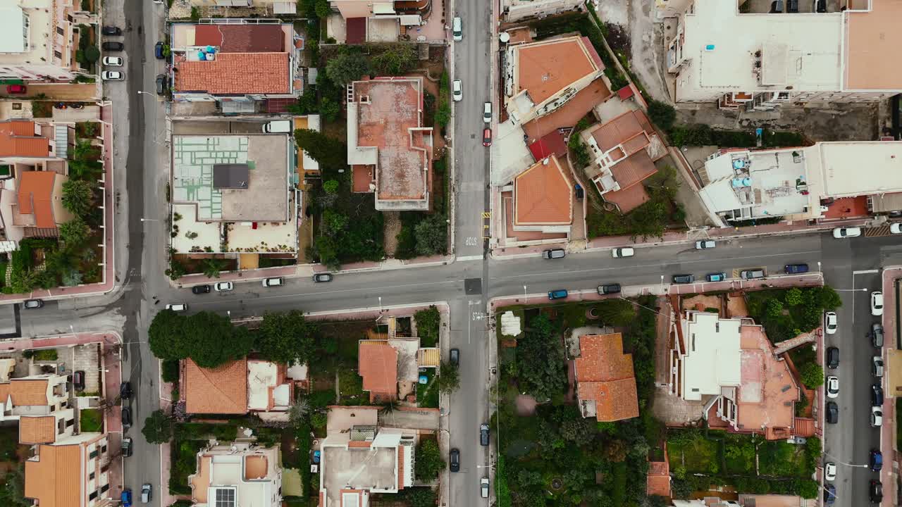 Top-down aerial shot of intersecting streets in Porticello near Palermo, showing Mediterranean-style homes, parked cars, and urban patterns in a quiet residential district
