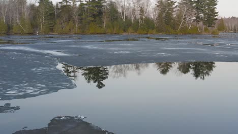 hebron lake in monson maine melting ice reflective water