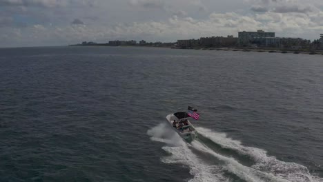 aerial-of-a-small-boat-with-an-american-flag-on-the-back