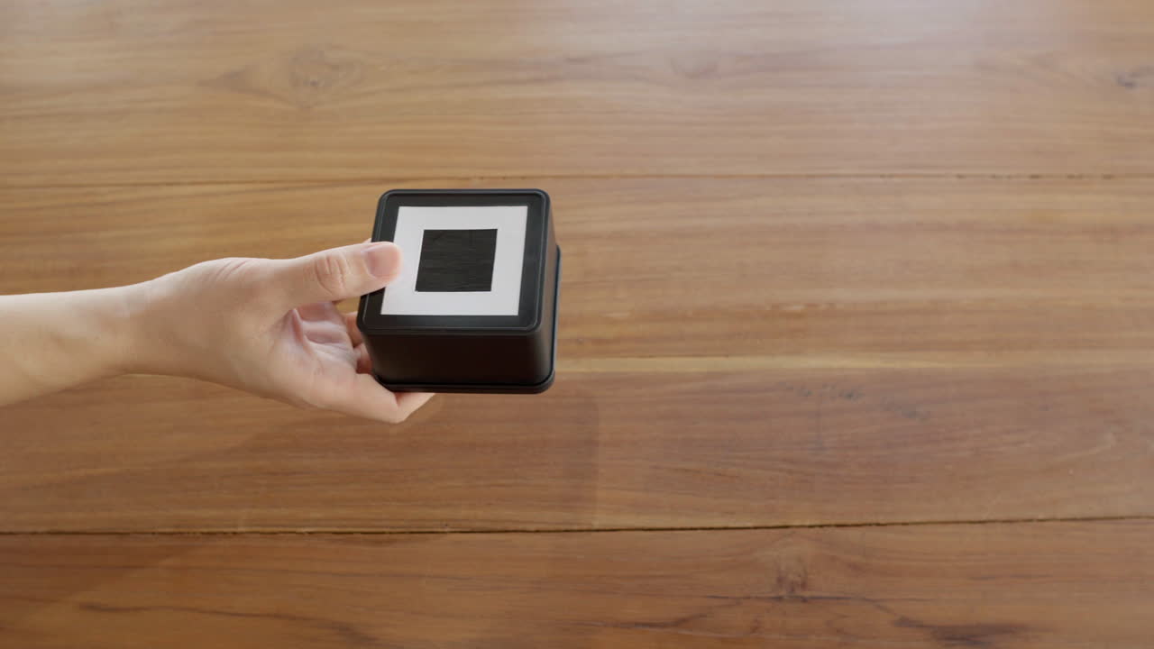 Close-up hands using mobile card reader terminal for contactless payment by tapping credit card