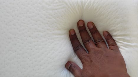 hand on a white mattress