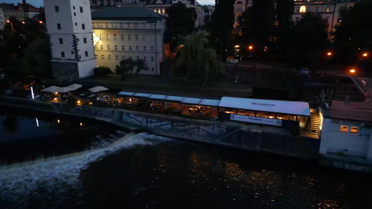 A magical aerial cinematic drone capture of Prague at night, showcasing the city's enchanting skyline with beautifully illuminated buildings, creating a captivating nighttime scene.