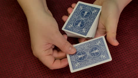 closeup of a magician's hands making a card trick