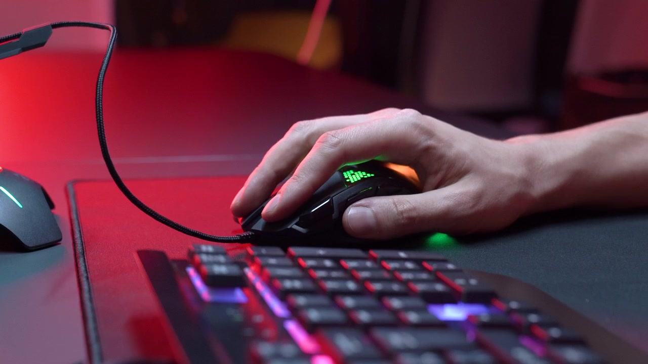 Close-up of a Hand Using a Gaming Mouse with RGB Lighting