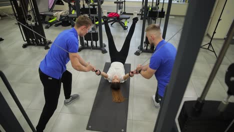 woman getting physical therapy on cable machine in a gym
