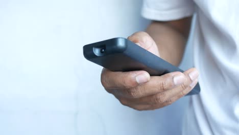 person holding a black tv remote