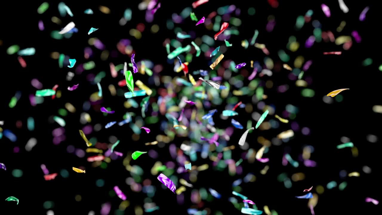 Confetti blasted upward falls slowly against a solid background.