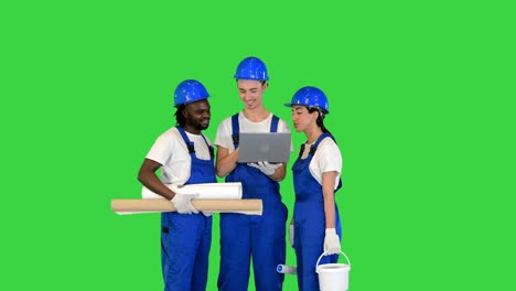 multiethnic diverse team of engineers working on a laptop on a green screen, chroma key