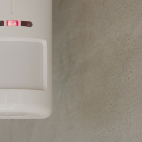 Security-alarm-sensor-on-the-wall-of-a-house-1