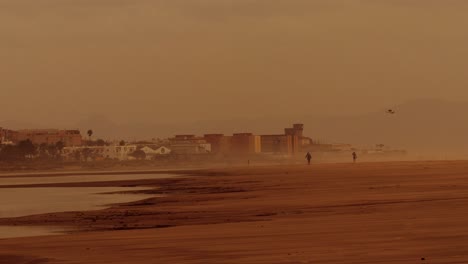 beautiful dreamy seaside with the people strolling the dunes in andalucia