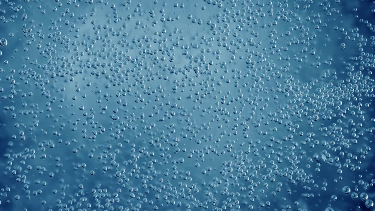 Oxygen bubbles in water on a blue abstract background