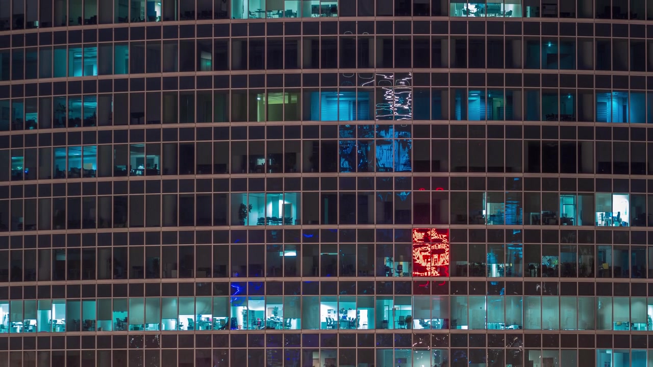 Close up view to office windows in Skyscrapers International Business Center of City at night timelapse from top