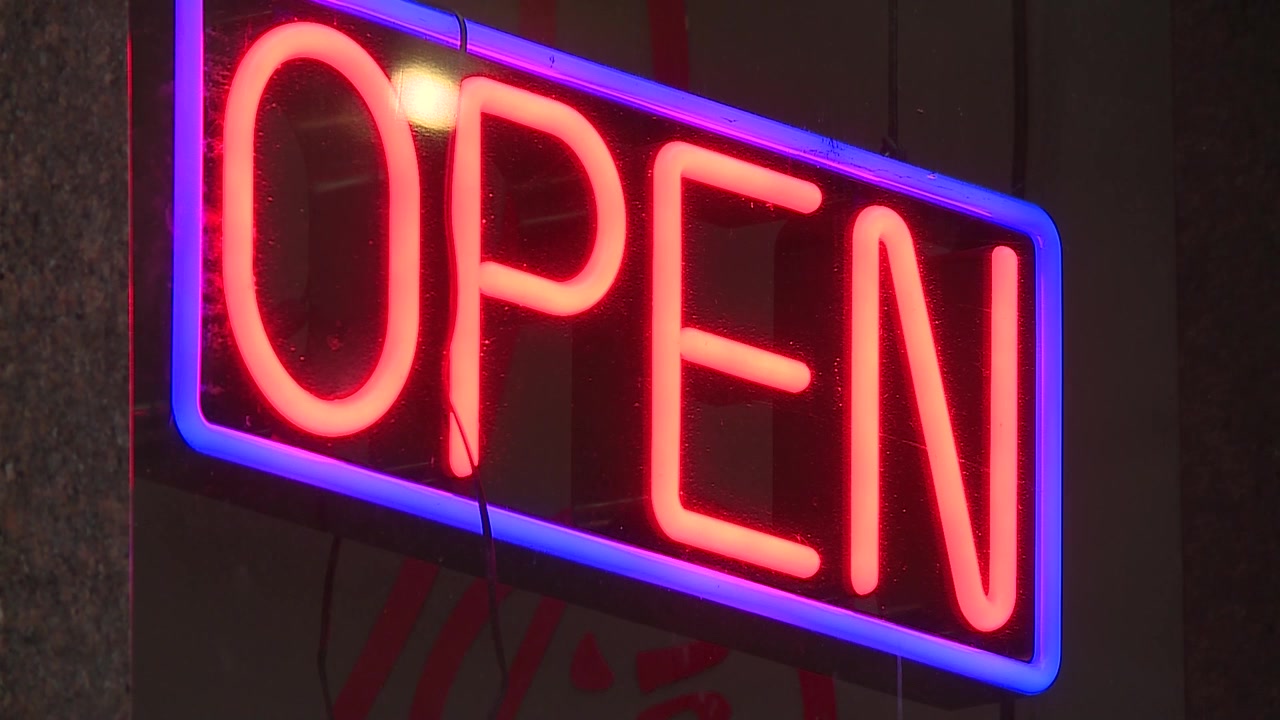 FLASHING NEON OPEN SIGN LITE UP AT NIGHT