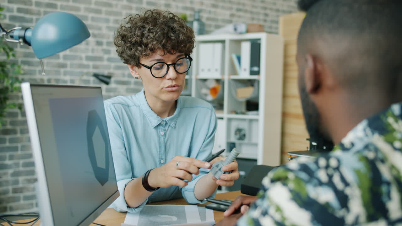 Design Team Discussing 3D Printed Prototype