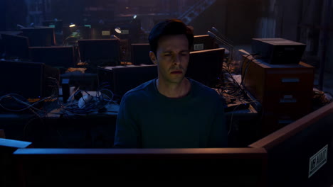 man experiencing stress and exhaustion while working with computers