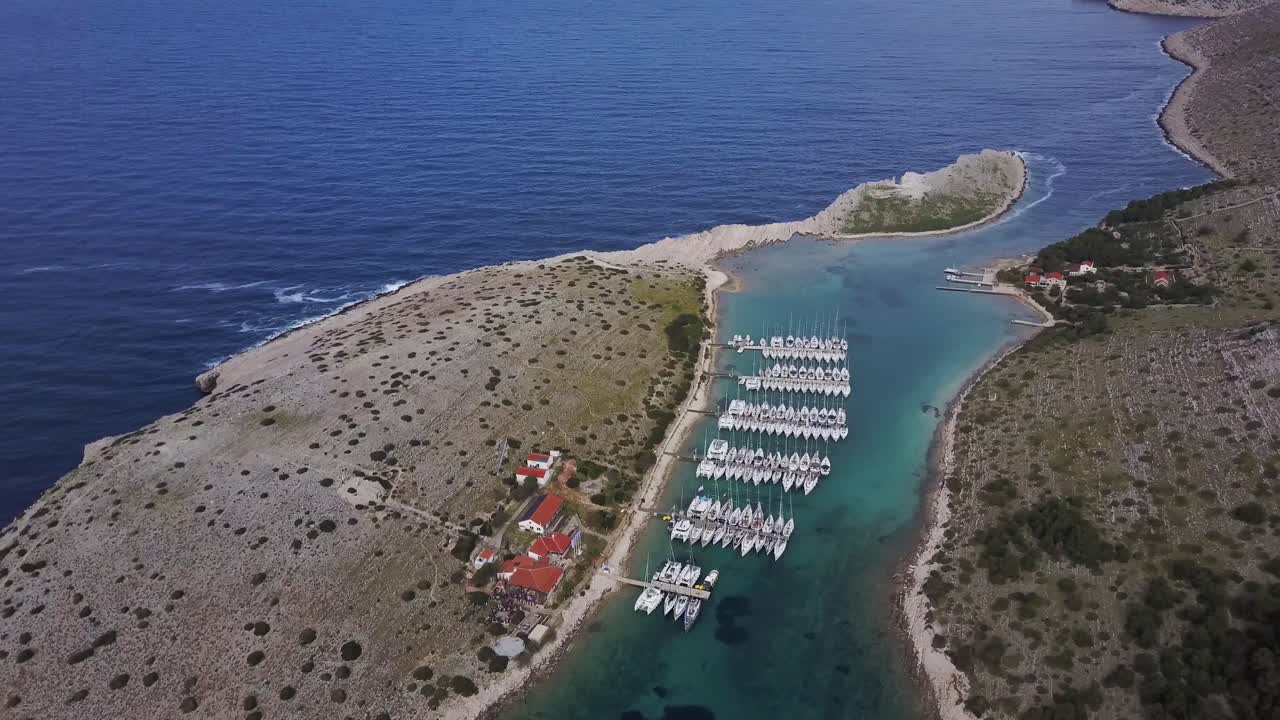 Sailboats moored in Marine Piskera, Kornati Islands in Croatia - Aerial Drone View