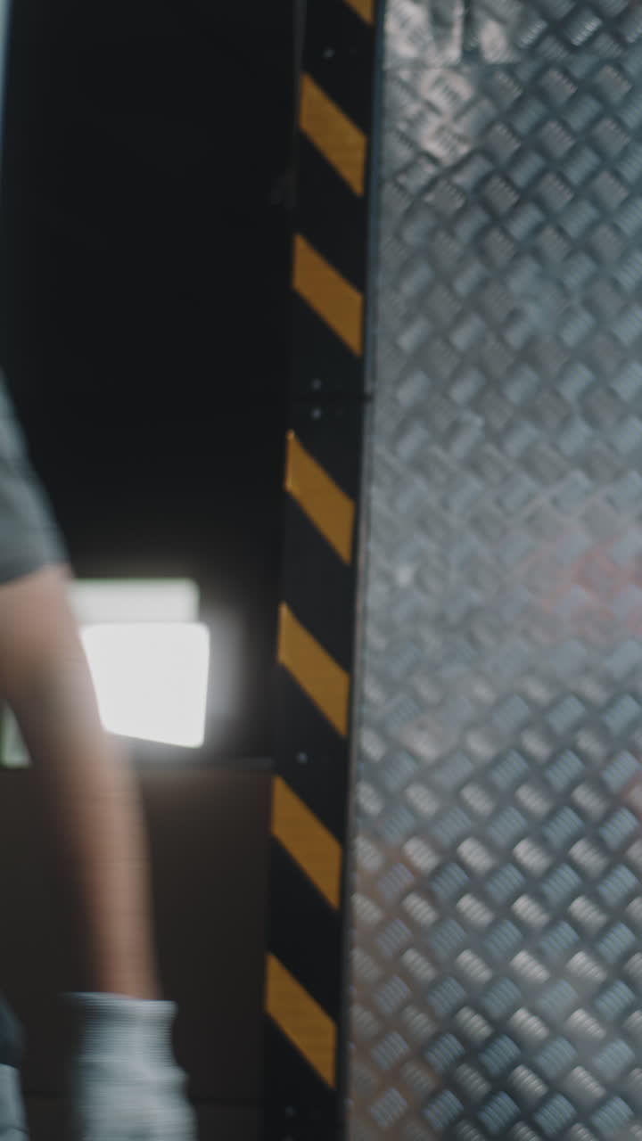 Man loading cardboard boxes into a truck