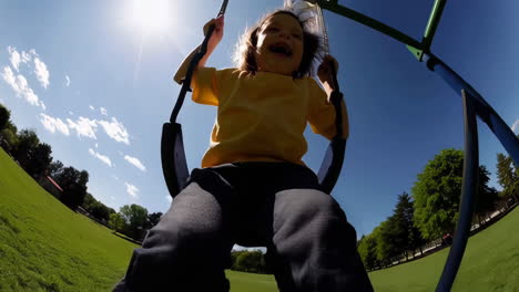 happy child playing on a swing in a sunny park