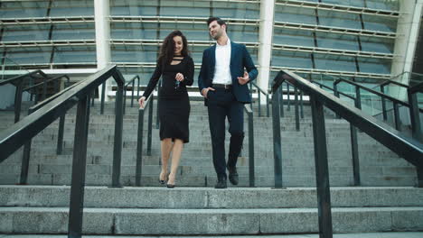 happy business man and woman talking on the street