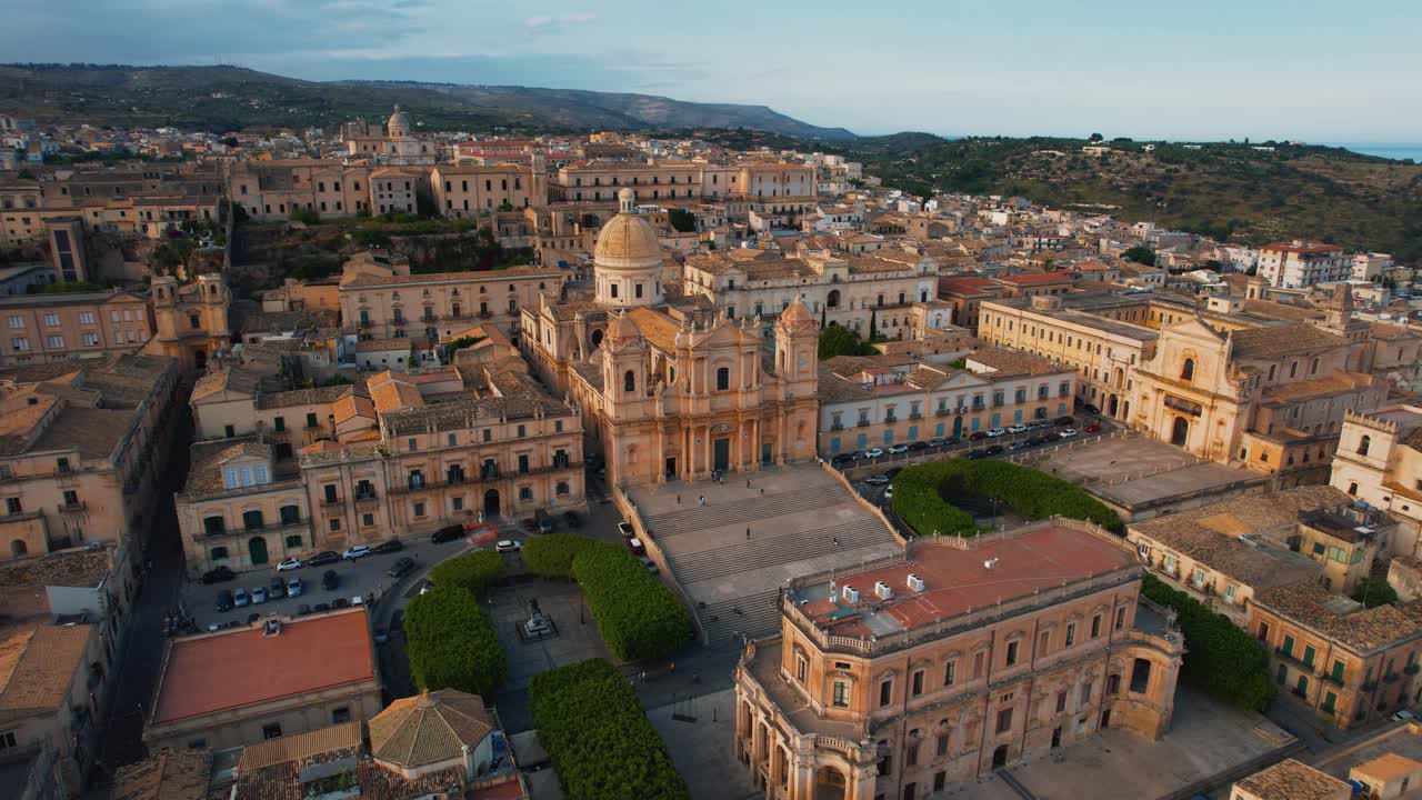Noto, Sicily with San Nicolò cathedral and piazza. Wide aerial view in sunset light. Scenic Italy.
