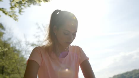 woman lunging while under trees on sunny day