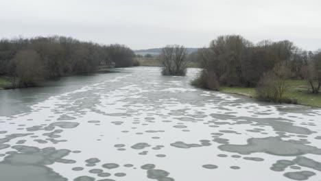 drone aerial footage of a 4k drone flying very close over a frozen lake in germany