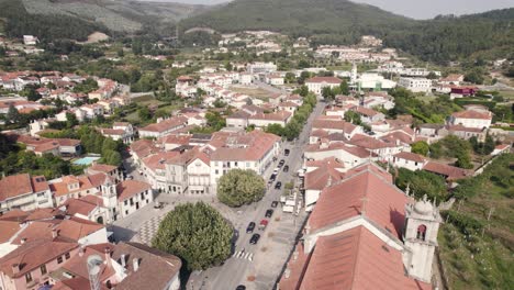 beautiful rooftops of arouca town surrounded by mountain range, aerial drone view