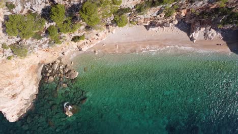 hidden sandy pasjaca beach at dalmatia, croatia - aerial top down ascending