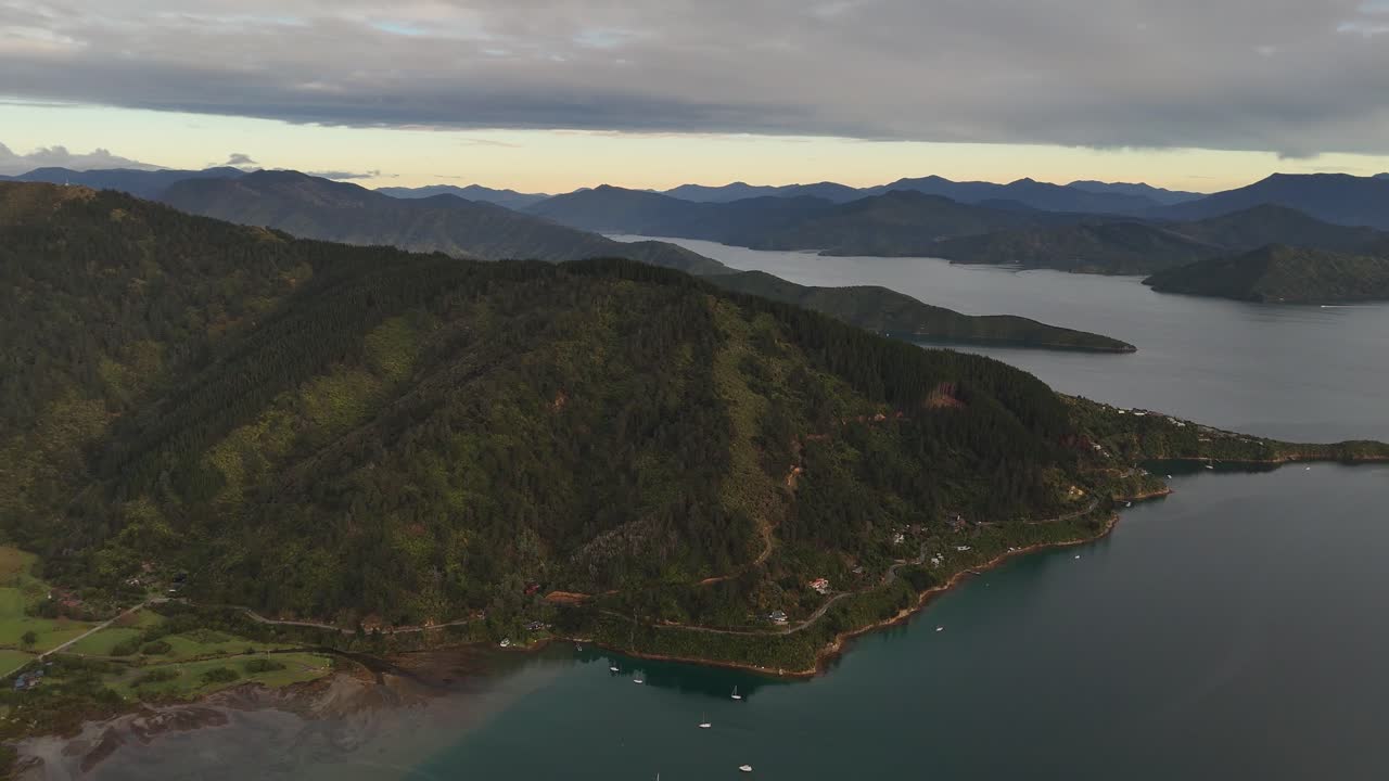 Aerial wide shot of sailing boats on Picton area with shoreline of town. Cook straight border between north and South Island of New Zealand