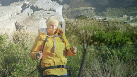 animation of mountains over caucasian female hiker walking