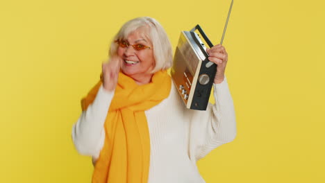 Happy-old-woman-listen-music-on-retro-tape-record-player,-disco-dancing,-fan-of-vintage-technologies